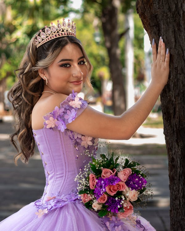 free-photo-of-woman-in-a-purple-dress-with-a-bouquet-of-flowers-in-her-hand